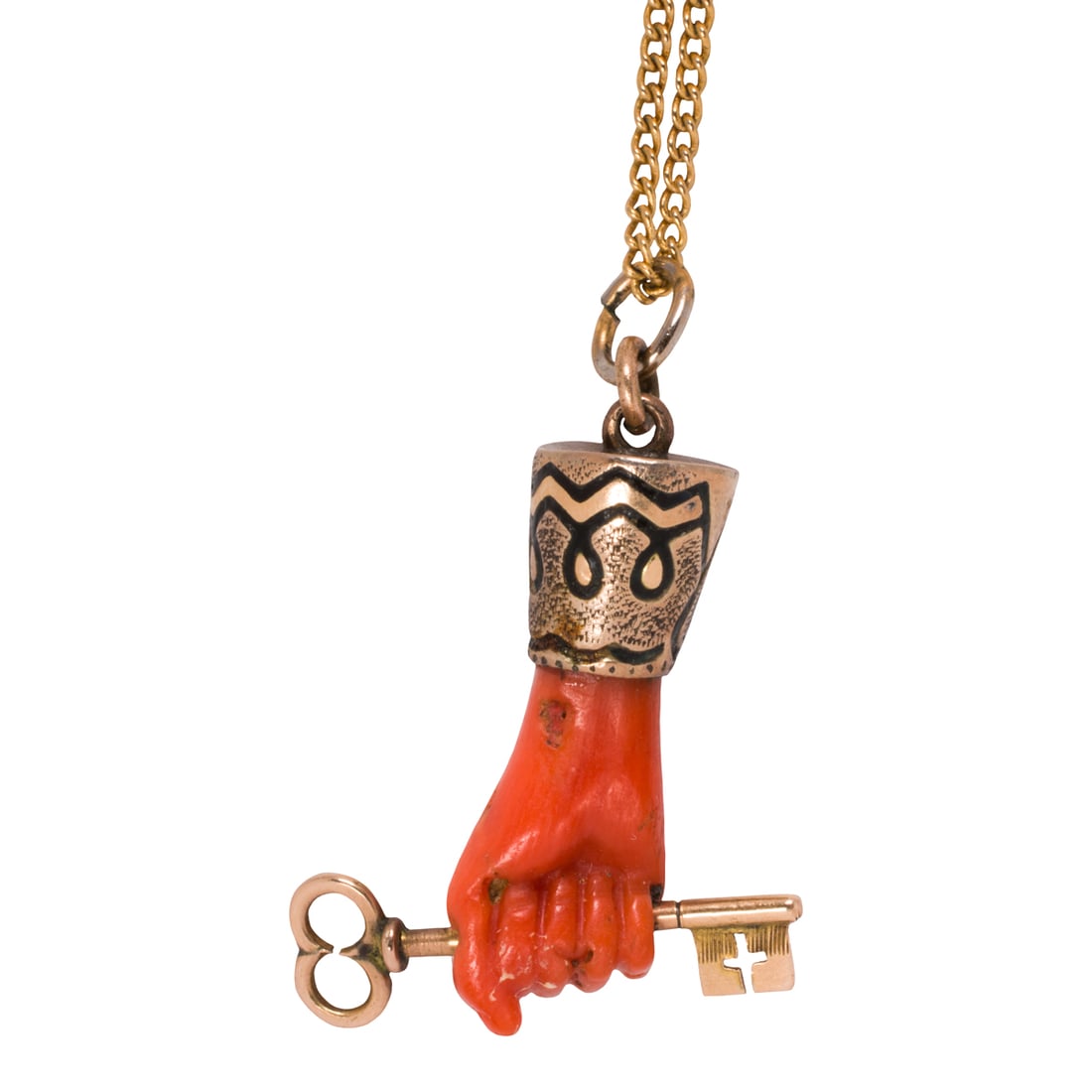 An antique coral and 14k gold Figa pendant necklace: An antique coral and 14k gold Figa pendant necklaceOf Figa design, featuring a carved coral hand holding a key, accented by d'epargne enameling; pendant length: 1 1/8 in; chain length: 18 1/4 in; 3.25