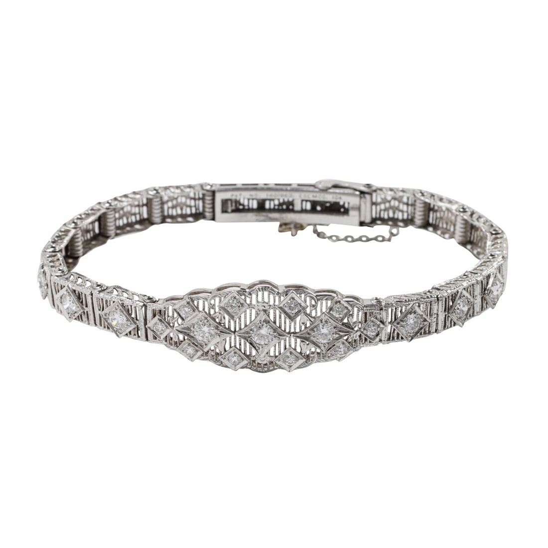 An Esemco Art Deco diamond and 10k white gold bracelet: An Esemco Art Deco diamond and 10k white gold braceletOf intricate open-form filigree design, centering an arrangement of 13 round brilliant-cut diamonds, framed on either side by two round brilliant-