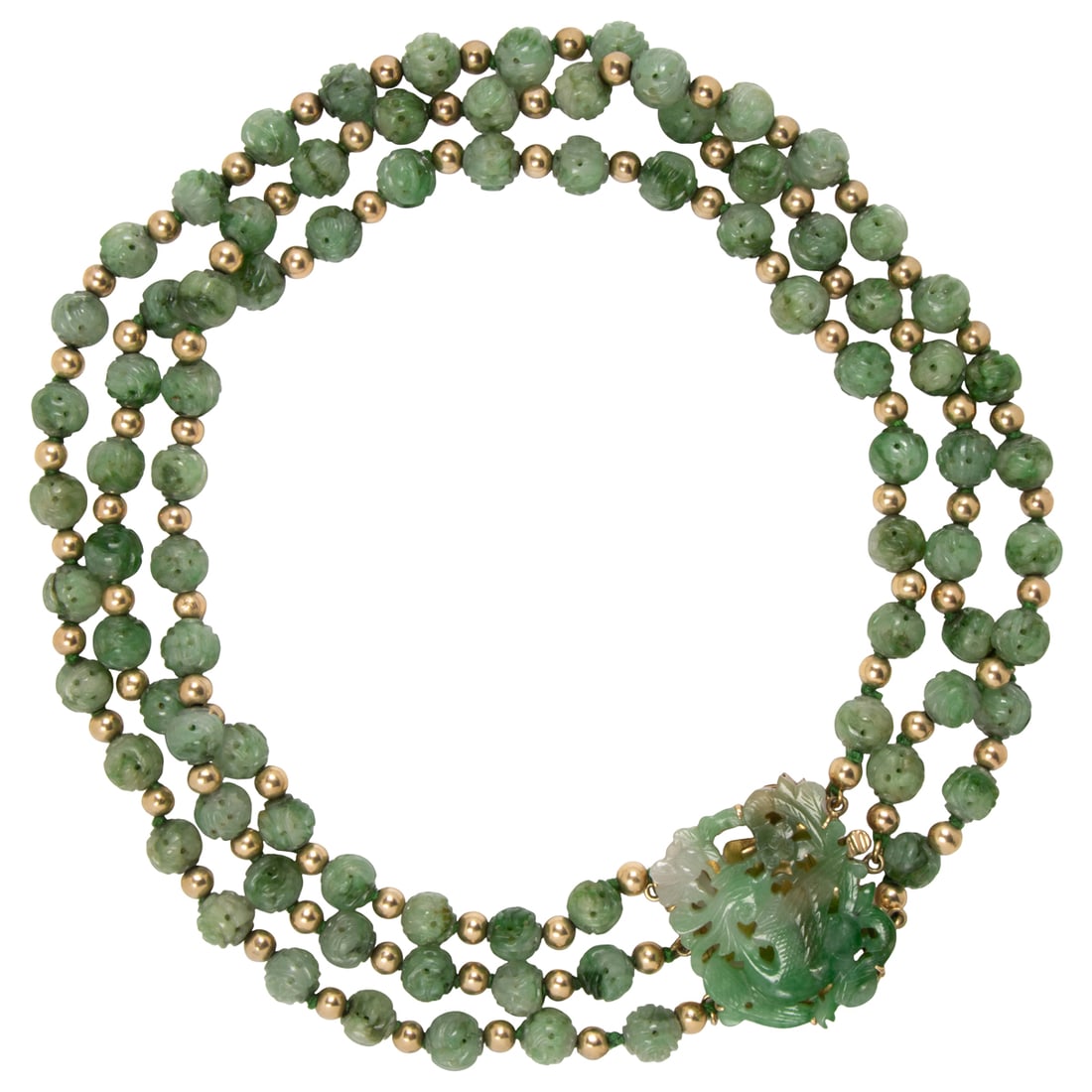 A carved jade and 14k gold beaded necklace: A carved jade and 14k gold beaded necklaceDesigned as a triple strand of intricately carved, open-form jade beads measuring 8.51 mm, interspersed by 14k gold beads measuring 5 mm, on clasp set with a