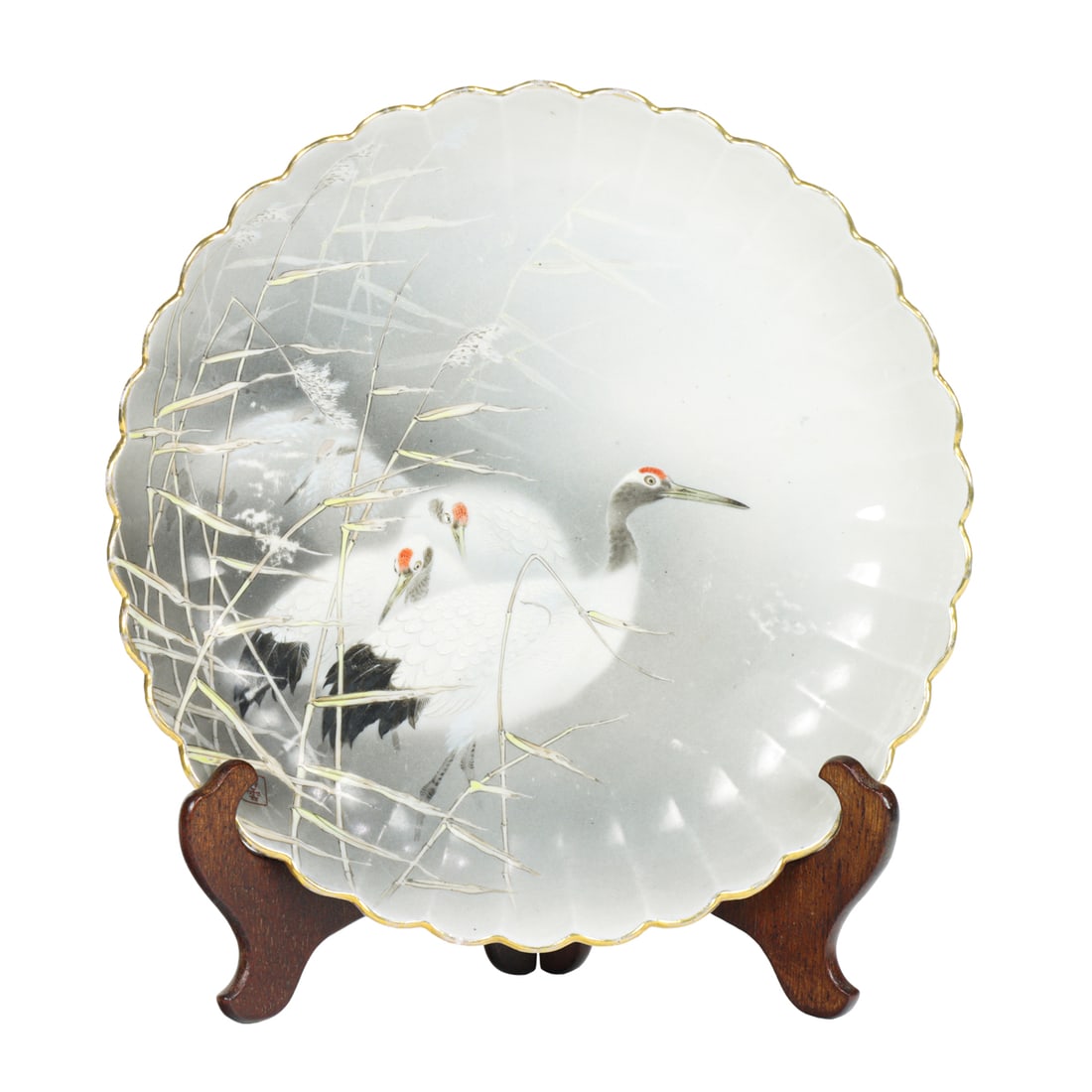 A Japanese enamel paiknted 'crane' chrysanthemum form porcelain dish: A Japanese enamel paiknted 'crane' chrysanthemum form porcelain dish. Meiji period, 12.375" across. Provenance: A. Burlingame Johnson (c. 1856-1934) collection, now offered by his descendant.