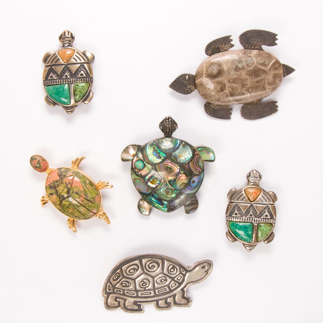 Five turtle brooches: Five turtle broochesComprising five silver and gold-filled brooches designed as turtles, set with various hardstones including fossilized coral; gross weight: 55.65 grams