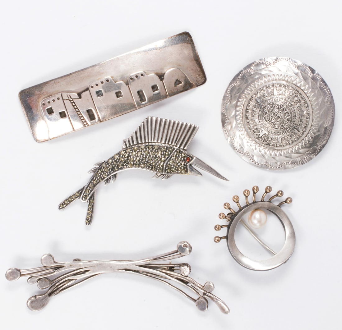 Five sterling silver brooches: Five sterling silver broochesComprising five sterling silver brooches of varying styles; gross weight: 44.75 grams