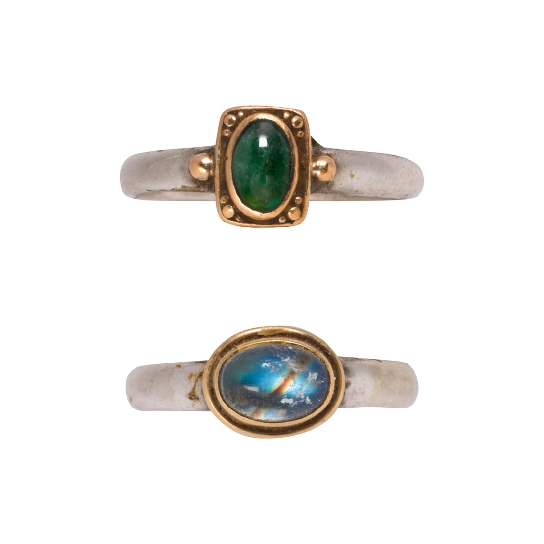Two stone-set, silver and gold rings: Two stone-set, silver and gold ringsboth sterling, one centering a 22k gold bezel-set oval-shaped emerald cabochon, and one centering an 18k gold bezel-set oval-shaped moonstone; sizes: 6 3/4 and 6
