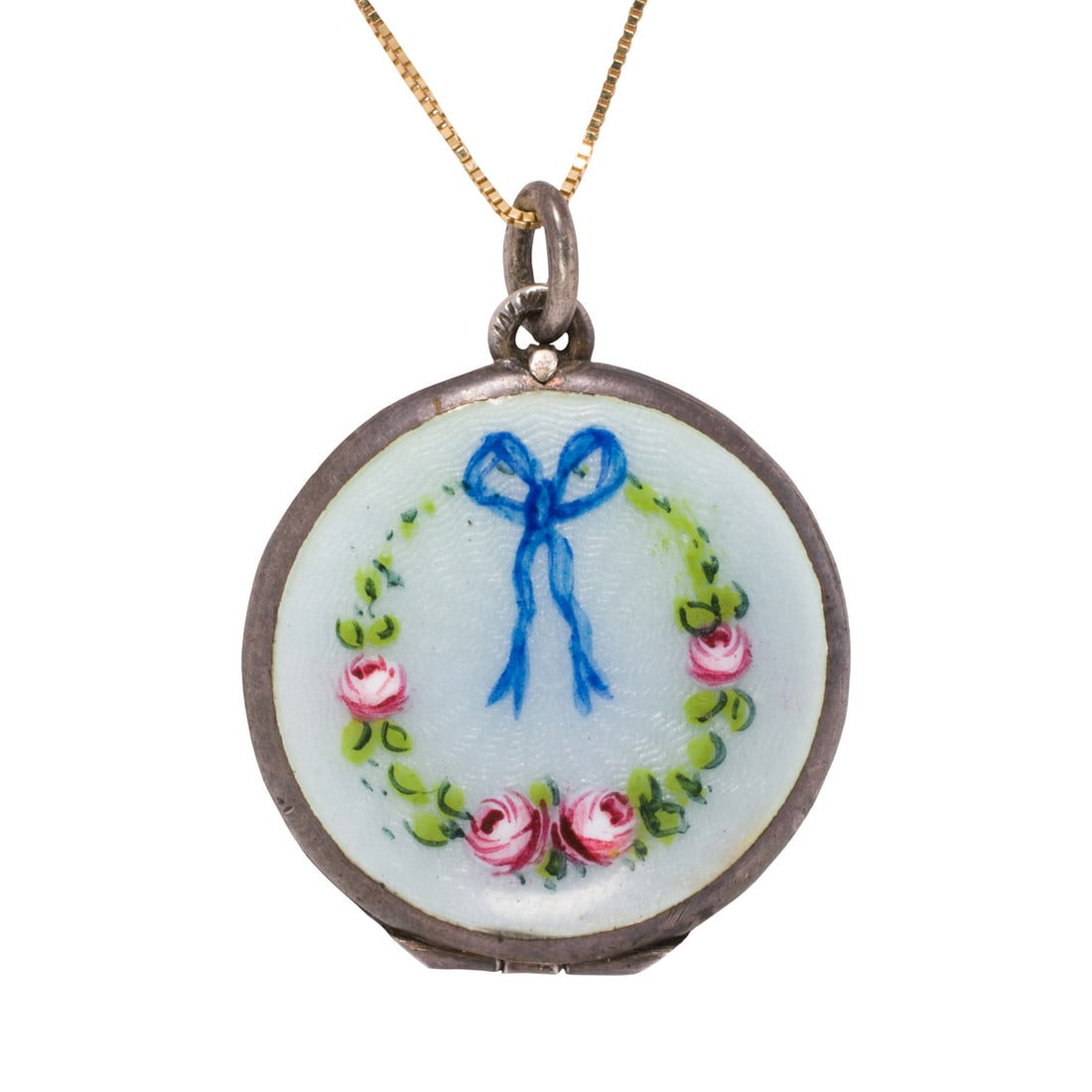 An antique silver locket: An antique silver locketFeaturing baby blue guilloche enamel, accented by a floral and ribbon garland design; length: 1 1/4 in; 4.90 grams