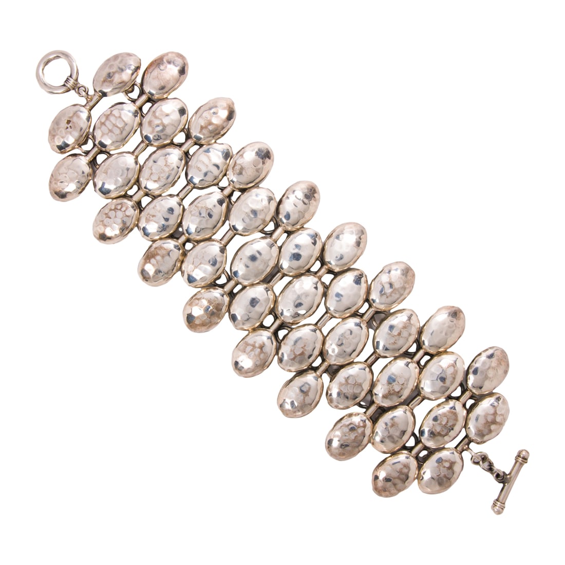 An Ilaria silver bracelet: An Ilaria silver braceletof articulated design with hammered texture; 79.0 grams; length: 7 1/2 in