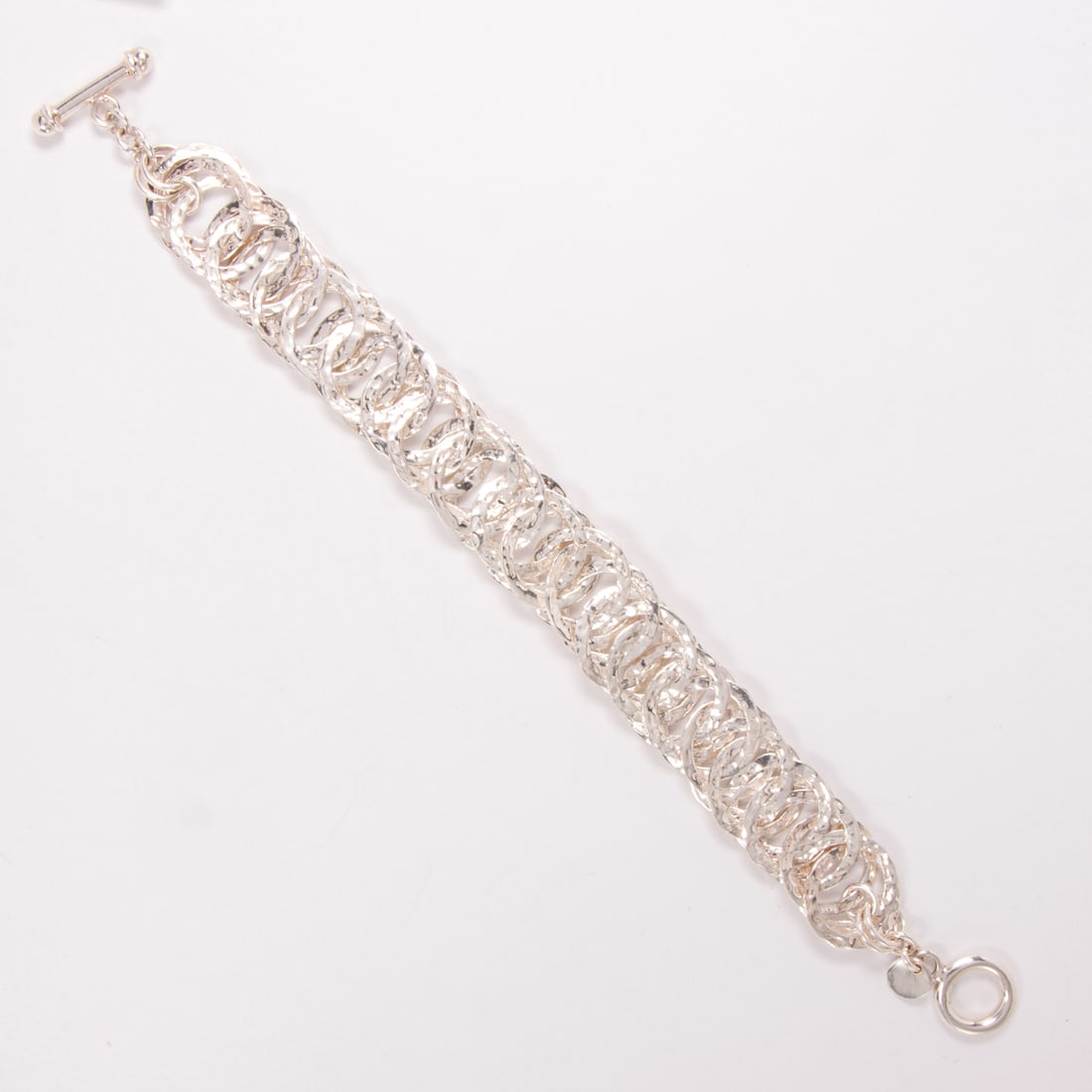 An Ilaria silver bracelet: An Ilaria silver braceletDesigned as a modified cable-link with hammered texture; 33.10 grams; length: 8 in