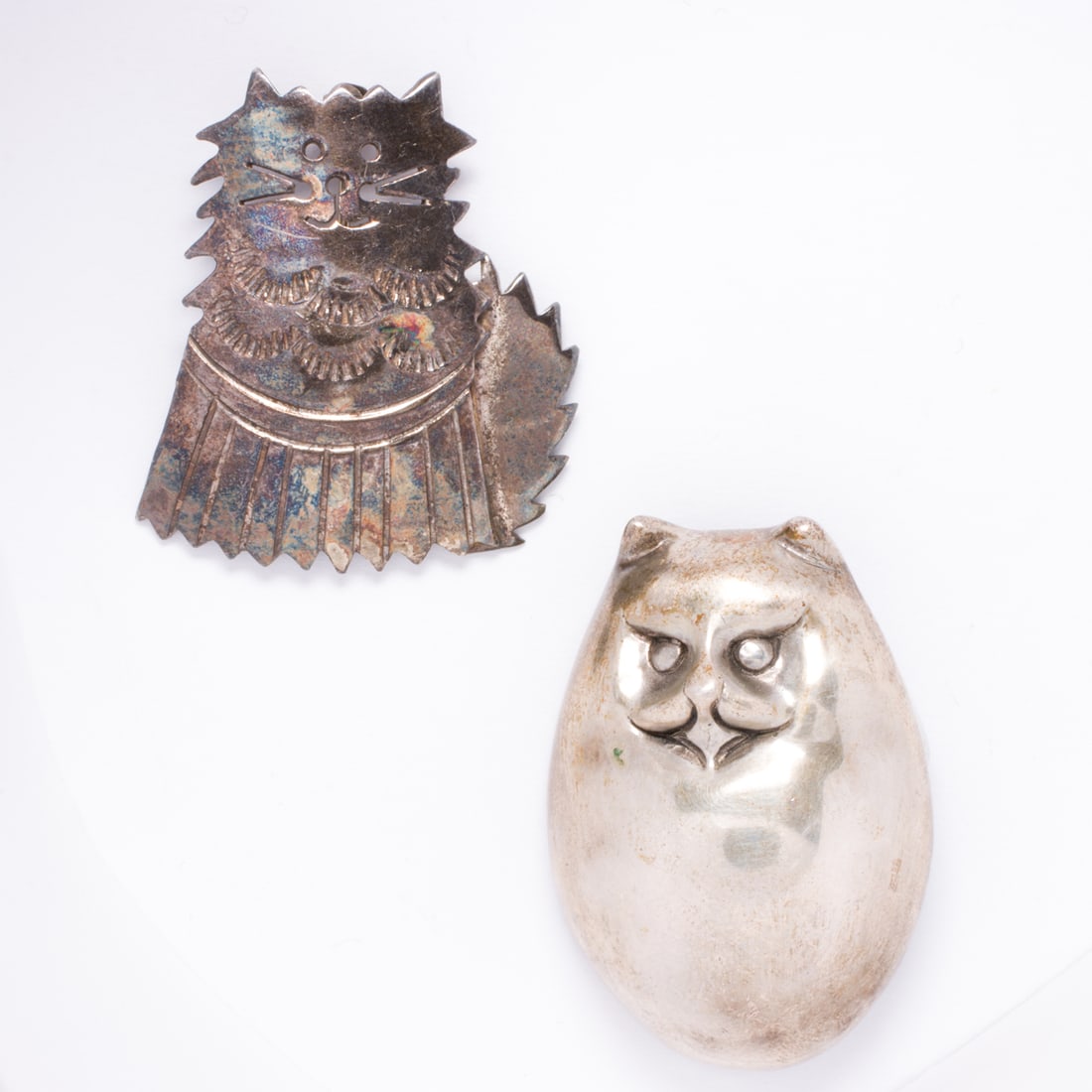 Two silver cat brooches: Two silver cat broochesEach of stylized cat design; lengths: 1 3/8 and 1 5/8 in; gross weight: 20.85 grams