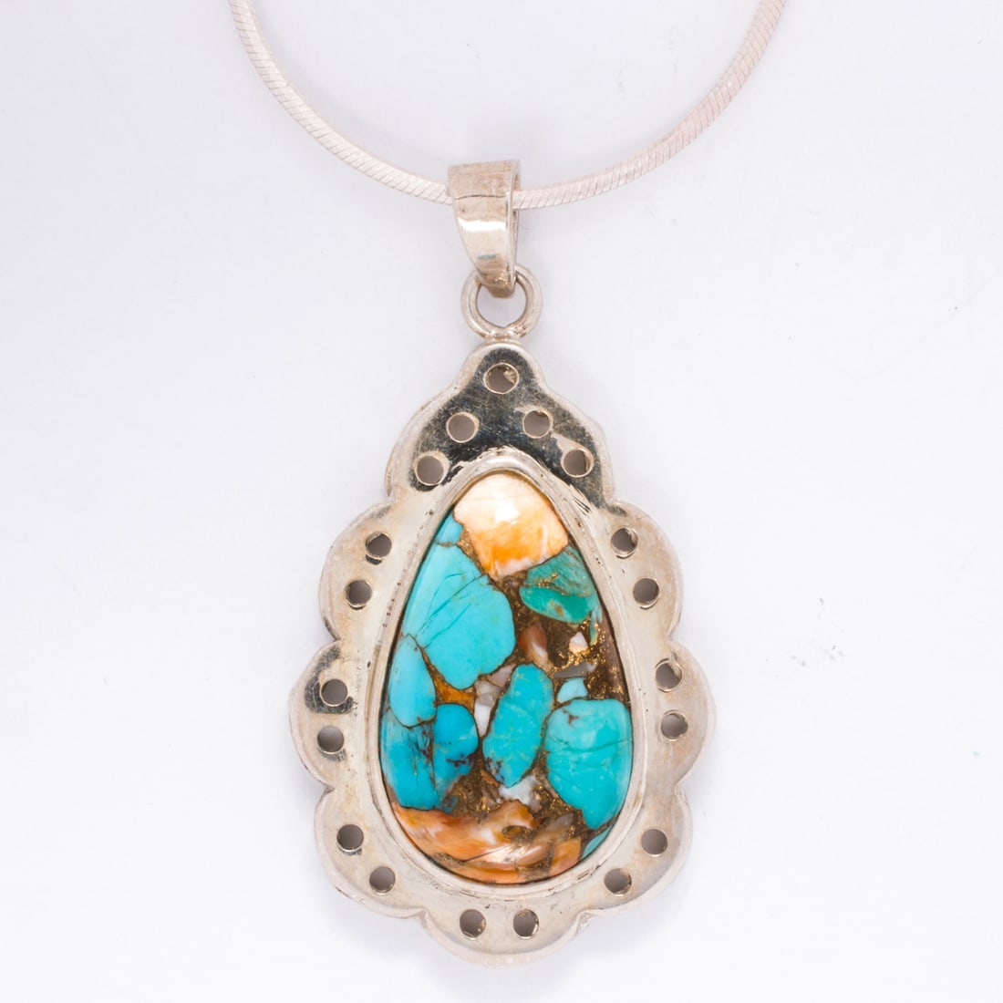 A hardstone and silver pendant necklace: A hardstone and silver pendant necklacecentering a composite stone cabochon, on modified snake-link chain; pendant length: 2 in; chain length: 24 in; 20.50 gross grams