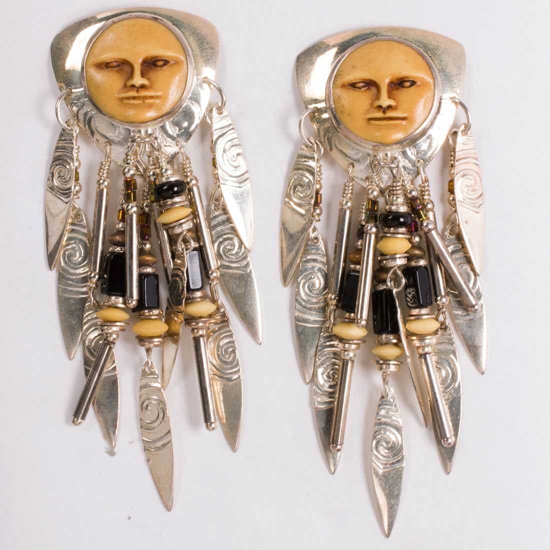 A pair of Tabra hardstone and sterling silver earrings: A pair of Tabra hardstone and sterling silver earringsDesigned with figurative surmount, accented by numerous hardstone and sterling silver beaded tassels; earring length: 3.00 in; 20.25 grams