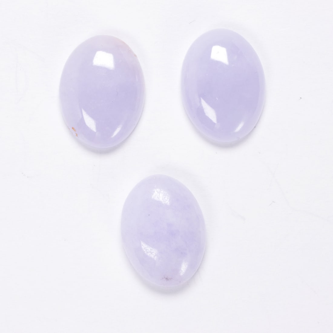 Three lavender jade cabochons: Three lavender jade cabochonsweighing in total 26.5 carats