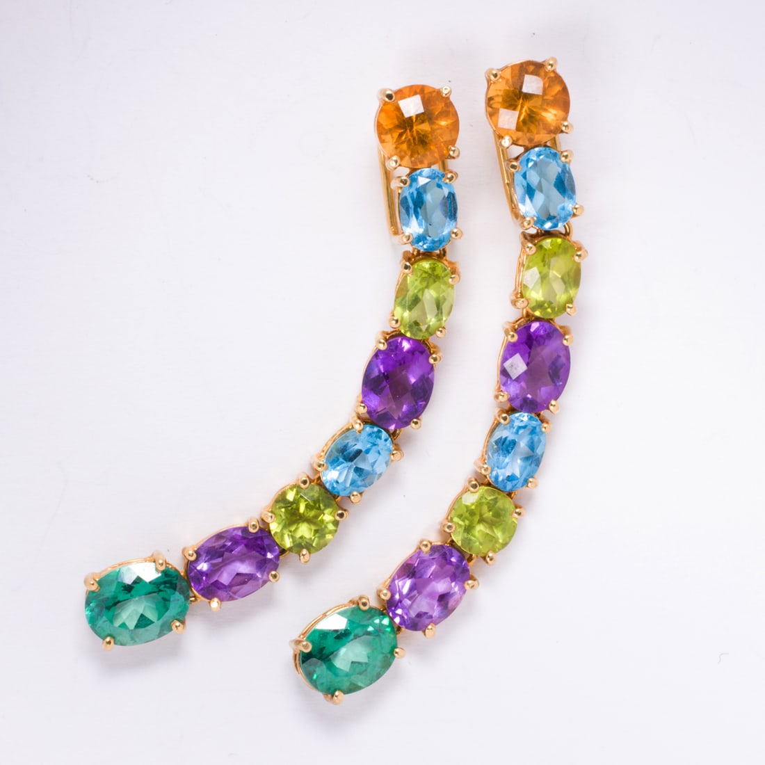 Two semi-precious gemstone and 14k gold slide pendants: Two semi-precious gemstone and 14k gold slide pendantsSet with numerous oval-cut semi-precious gemstones including amethyst; length: 2 1/2 in; gross weight: 10.30 grams