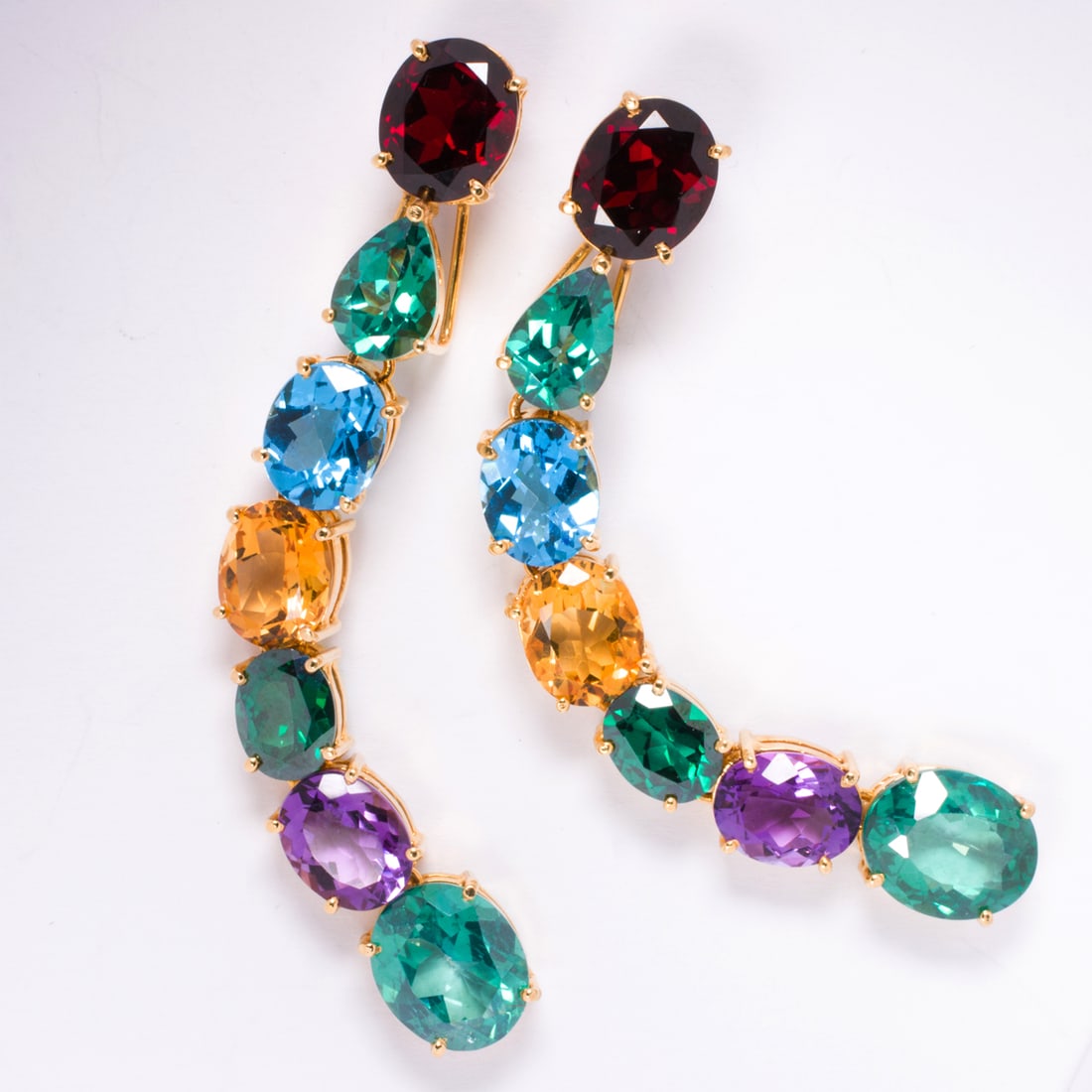 Two semi-precious gemstone and 14k gold slide pendants: Two semi-precious gemstone and 14k gold slide pendantsSet with numerous oval and pear-cut semi-precious gemstones including garnet; length: 3 in; gross weight: 19.70 grams