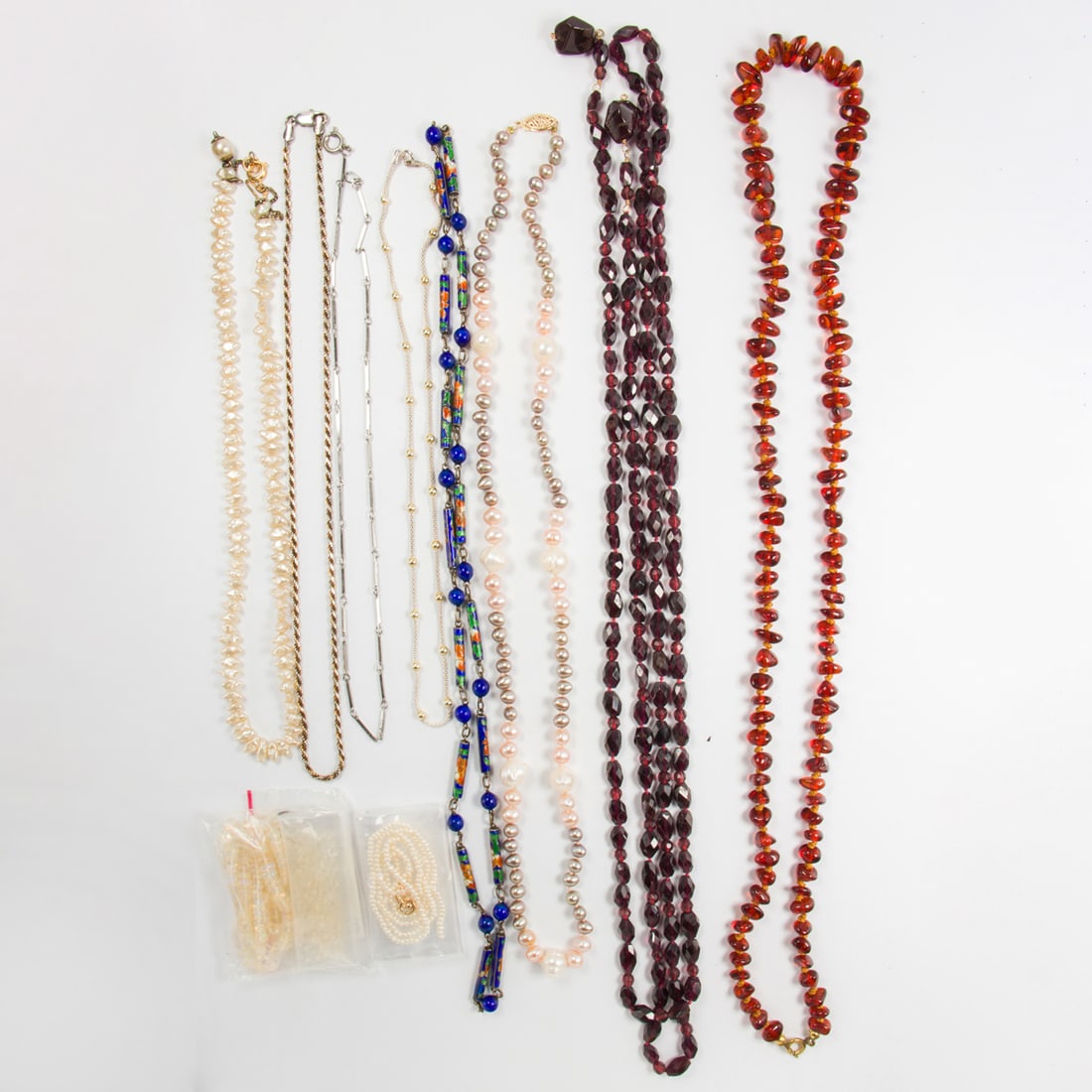 A miscellaneous group of beaded necklaces: A miscellaneous group of beaded necklacesComprising an assortment of beaded necklaces of varying materials including cultured pearls and garnet; gross weight: 162.45 grams