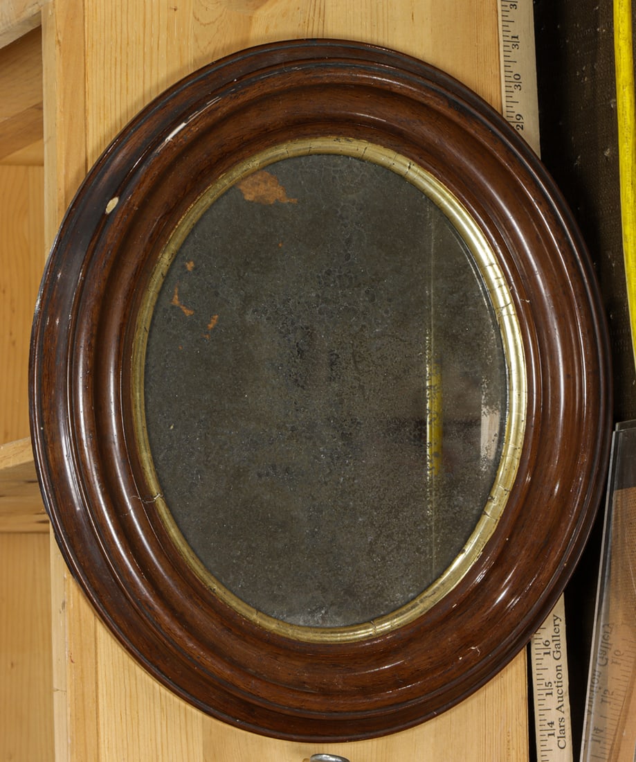A small English oval mirror with giltwood slip: A small English oval mirror with giltwood slip, 17"h x 15"w