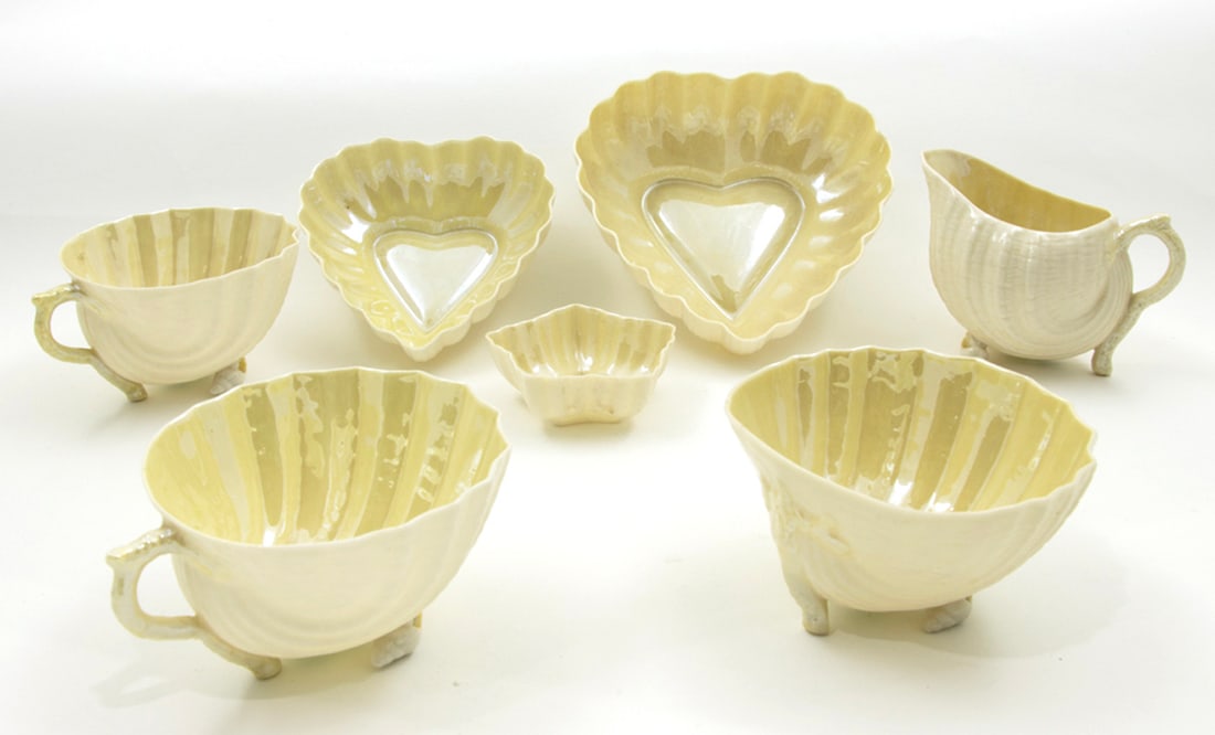 A group of Belleek porcelain: A group of Belleek porcelain, the first group in the Neptune pattern, comprising (2) cups; (1) open sugar and (1) creamer; the second group in various patterns comprising (2) graduated heart dishes,