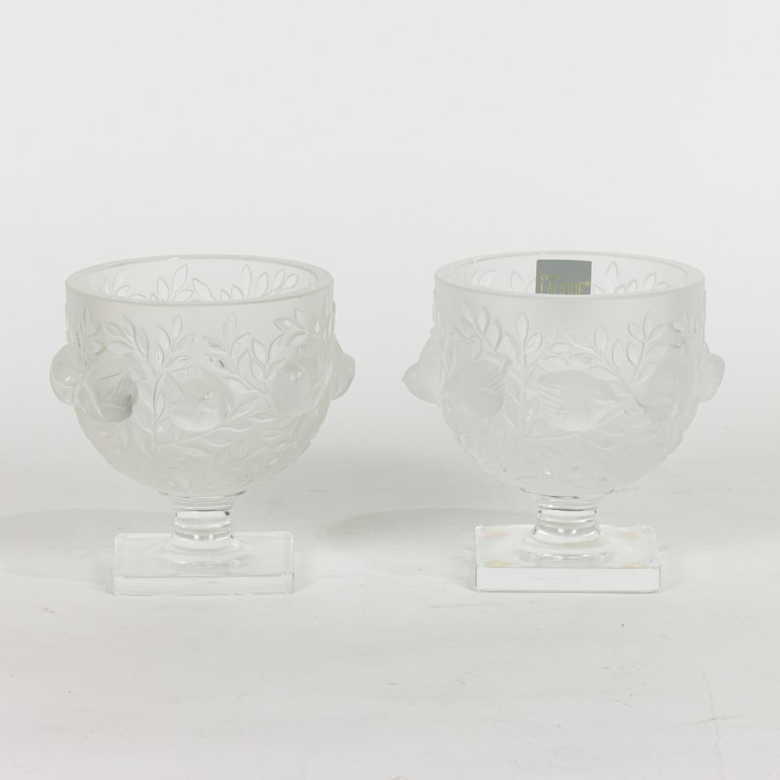A pair of Lalique glass Elizabeth footed vases: A pair of Lalique glass Elizabeth footed vases, depicting sparrows perched among branches, engraved factory mark, 5.25"h x 4.75"dia [2 total]