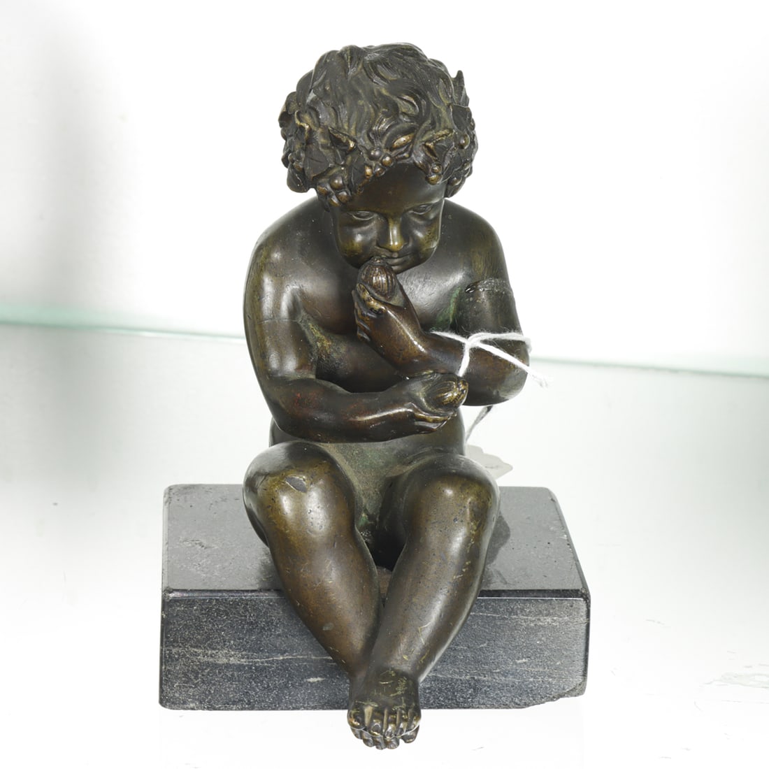 A Continental Bronze Figure of an Infant Satyr on Black Granite Base: A Continental patinated bronze figure of an infant satyr on black granite base, unmarked, 5.75"h