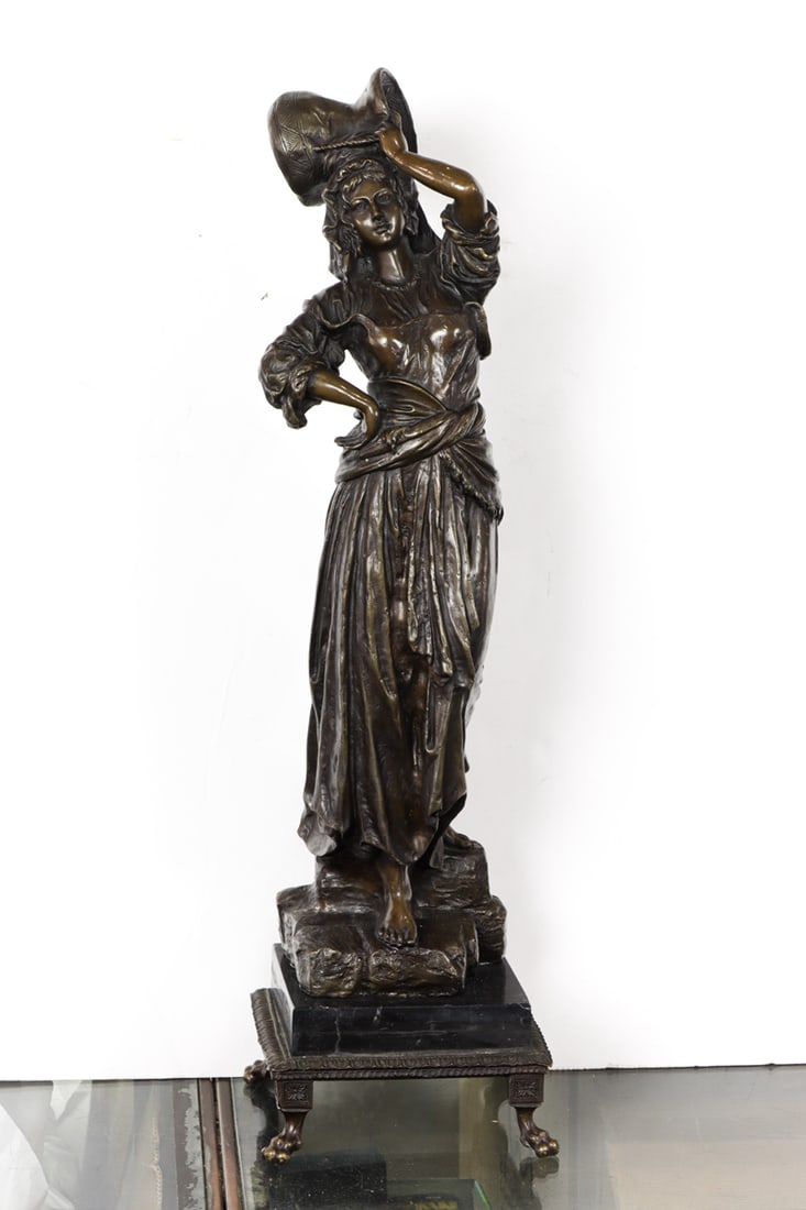 A Continental style patinated bronze figure of a water carrier (1 of 1)
