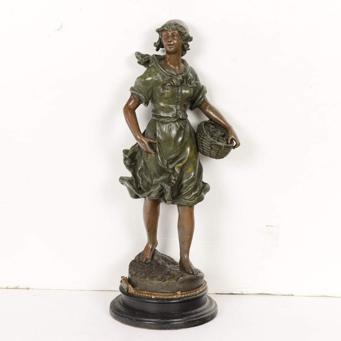 A Continental patinated metal figure of a young woman: Pecheuse de Crevsites: A Continental patinated metal figure of a young woman: Pecheuse de Crevsites, late 19th/early 20th century, after a model by Rousseau, 15.5"h x 6"dia (base)