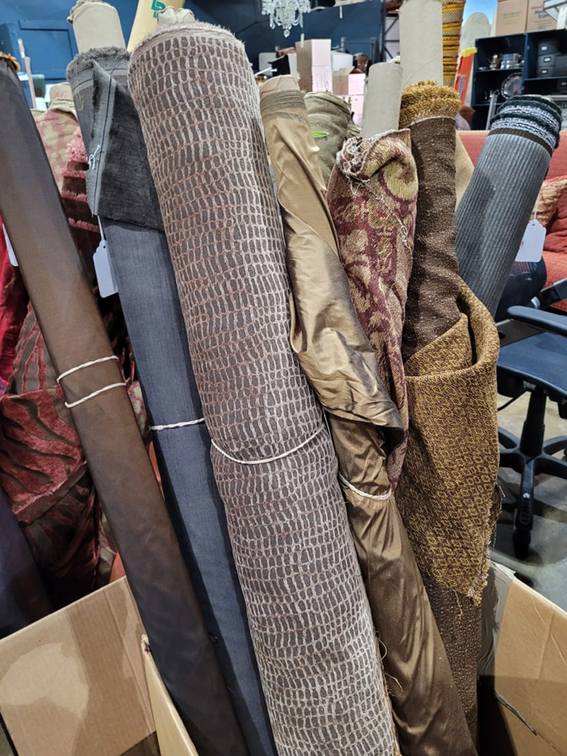 A group of eight dark brown with wheat and red tone fabrics: A group of eight dark brown with wheat and red tone fabrics, largest 60"w