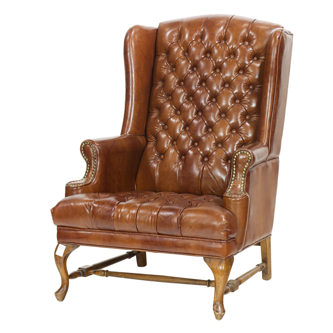 An English style faux-leather tufted wingback chair: An English style faux-leather tufted wingback chair, embellished with nailhead trim and raised on cabriole legs, 44.5"h x 29"w x 26"d (overall)