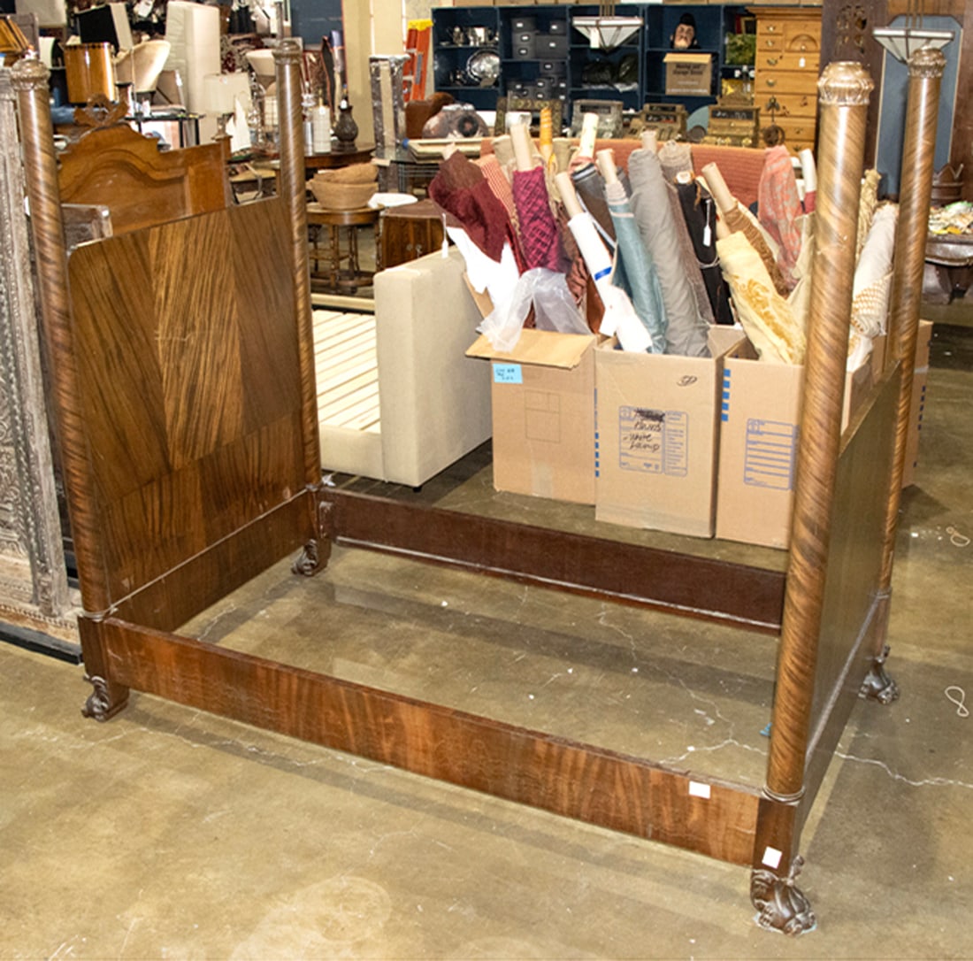 A figured wood four-post single bed: A figured wood four-post single bed, late 19th/early 20th century, raised on animal paw feet, 72"h x 78"w x 45"d, Provenance: Property from the estate of Patricia Moffat Pope, San Francisco, CA