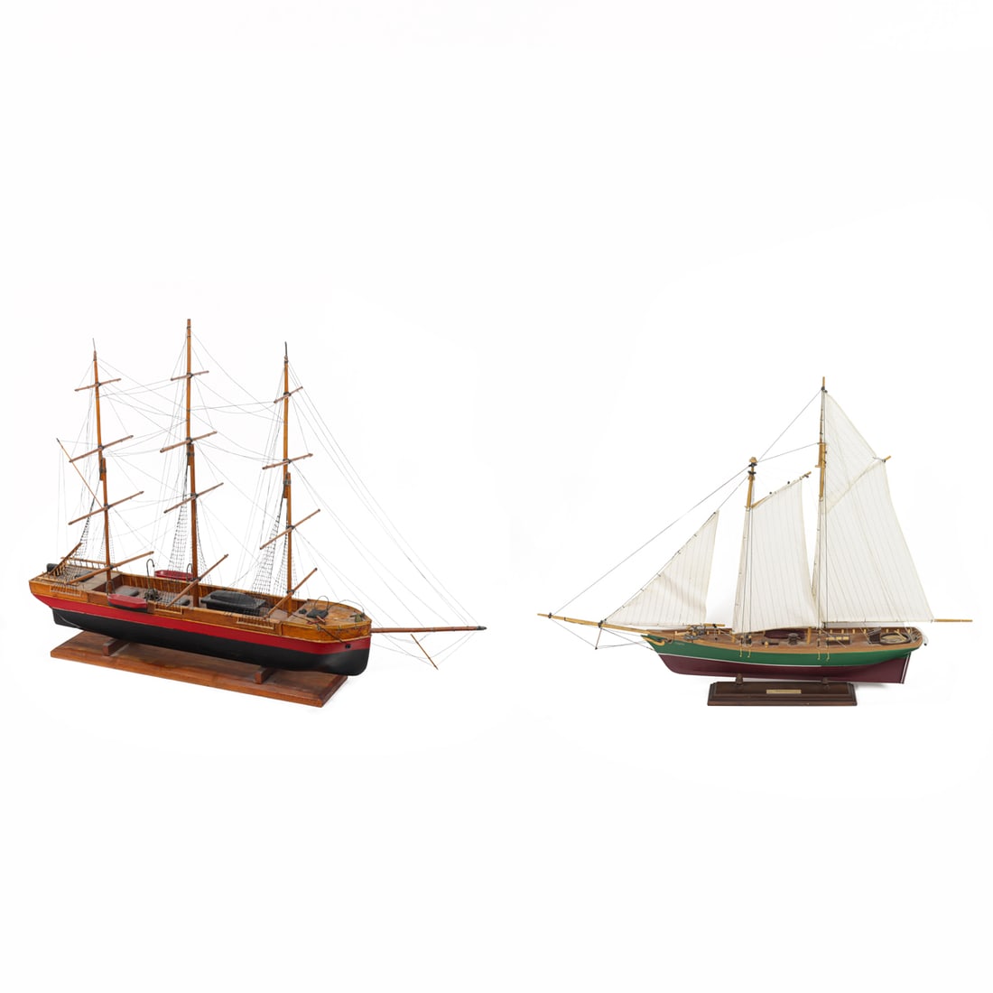 Two three-mast sailboat models: Two three-mast sailboat models, the first example painted red and black, overall 23"h x 30.5"w x 4.5"d; the second example of American, painted green and burgundy, 21.5"h x 28.5"w x 3.5"d