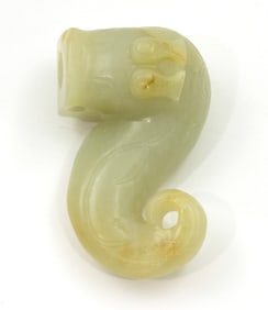 A Chinese russet and celadon jade dragon toggle