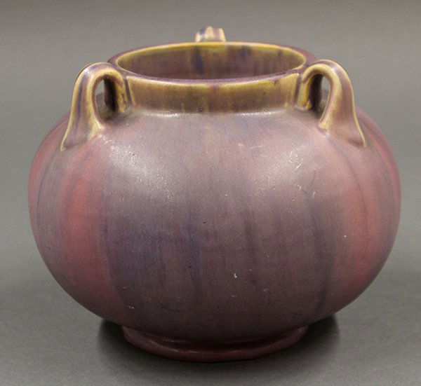 Fulper art pottery vase: Fulper art pottery vase, the bulbous form executed in the Arts and Crafts taste and having a three handled rim terminating at the sloping shoulder, covered in a matte lavendar to mauve glaze and risin