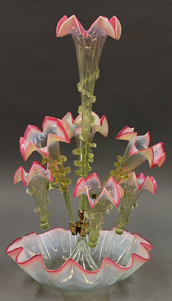 Victorian art glass epergne: Victorian art glass epergne, circa 1880. Having center trumpet surrounded by six alternating angled trumpets all with rigaree. Resting in a ruffled edge bowl. Executed in green opalescent glass with c