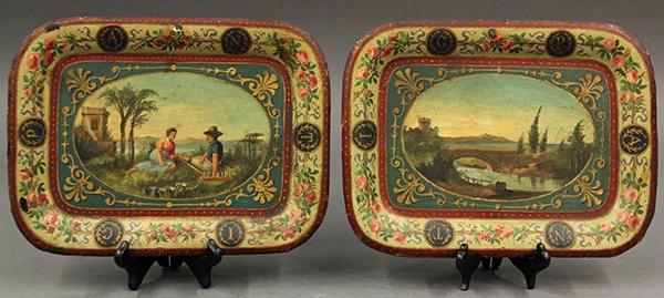 Tole serving trays: (lot of 2) Tole serving trays, late 19th or early 20th century. Diminutive rectangular trays with bucolic scenes. One depicts a landscape with a river and bridge, the other, a peasant couple picnicing