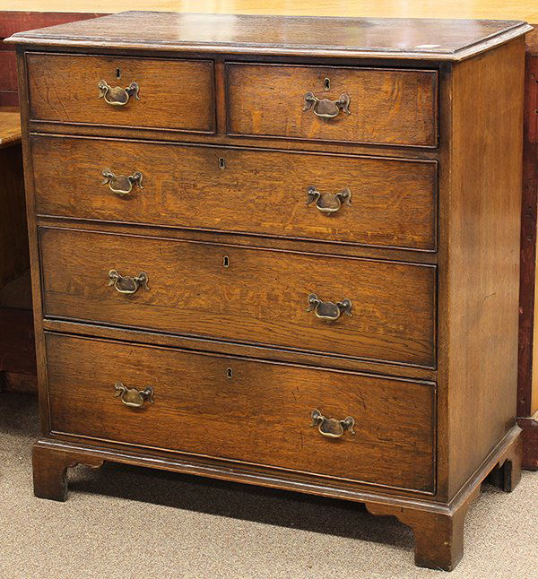 George III chest of drawers: George III chest of drawers, circa 1780, executed in quartersawn oak, the five drawer case with cock beading, centered with later bat wing brasses and rising on bracket feet, 38"h x 37"w x 19"d