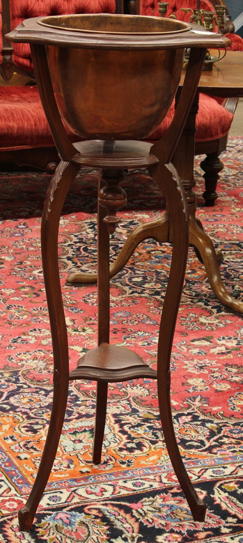 Late Victorian walnut fern stand: Late Victorian walnut fern stand, having a copper bowl centering the shaped top, the three supports continuing to the circular tier and rising on cabriole legs, 39"h x 18"w