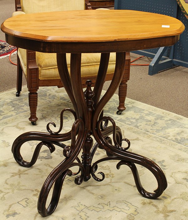 Thonet bentwood center table: Thonet bentwood center table, 19th century. Oval top surmounts a a base with center turned standard and sinuously curved feet. Overall: 32"h x 32"w x 19"d.