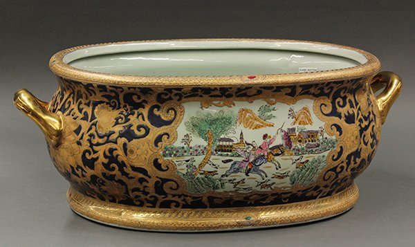 Victorian style partial gilt jardiniere, executed in: Victorian style partial gilt jardiniere, executed in the Asian taste. Of oval form with gilt handles. Having yellow floral decoration on cobalt ground flanking the central reserves on either side depi