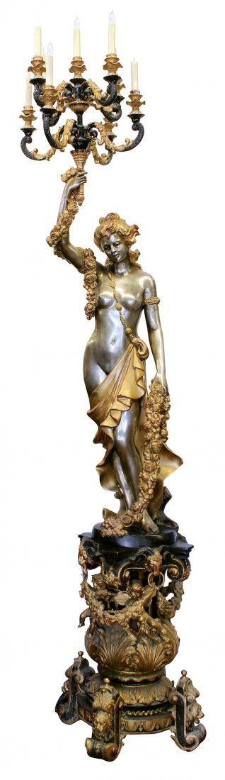 Classical style figural torchiere: Classical style figural torchiere, the patinated fixture with an eight light candelabra supported by a nude maiden, her right arm with a garland swag cascading to her torso, above a partial gilt base 
