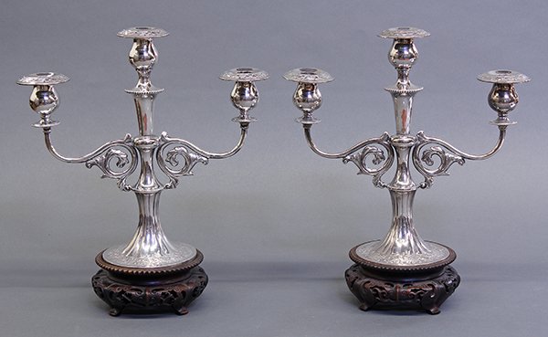 Pair of Chinese silver three-light candelabra.: Pair of Chinese silver three-light candelabra, each Renaissance style form having removeable bobeches, scroll branches, and impressed floral accents against a finely hammered ground, with bases, Tianj