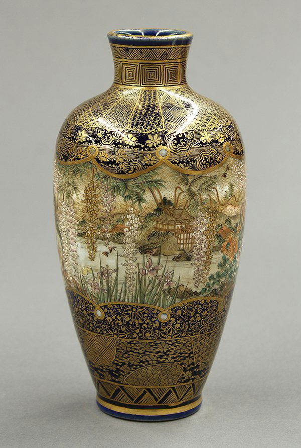 Japanese Kyo-Satsuma Kinkozan Vase: Japanese Satsuma-style gilt enameled earthenware vase, Meiji period, the foreground with wisteria, iris, peonies, and flowering trees in contrast with the villa across the river bank, reserved on a bl