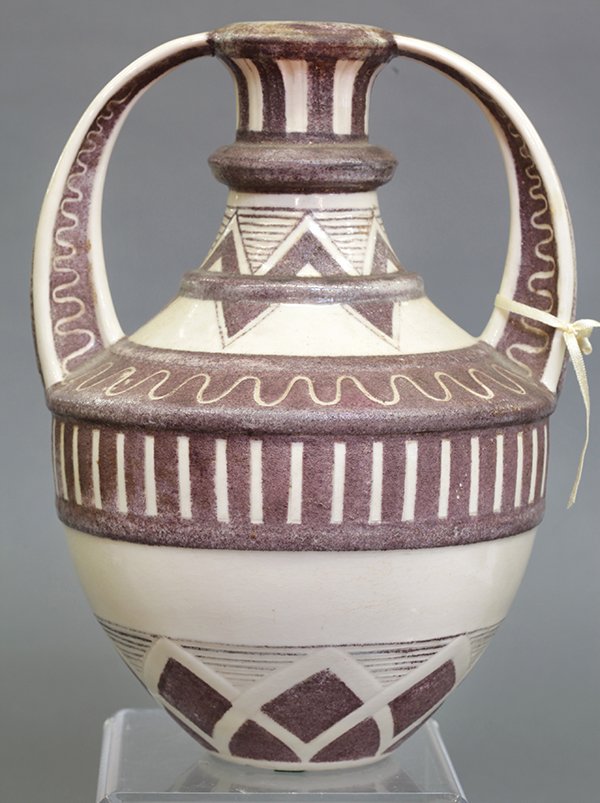Zsolnay style handled urn: Zsolnay style handled urn having abstract geometric designs on a cream ground, 12"h