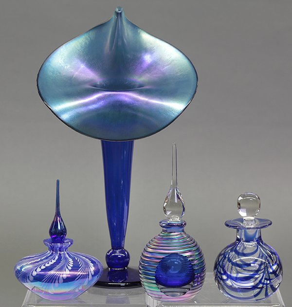 Art glass group: (lot of 4) Art glass group consisting of a signed blown glass vase having an iridescent blue ground, together with three scent bottles, two with tear drop stoppers, another with blue accents on a clea