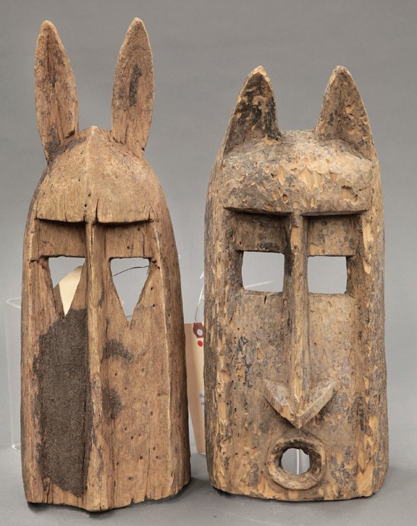 Dogon, Mali animal masks: (lot of 2) Dogon, Mali animal masks consisting of one having cat style ears, square eyes, round mouth, and dry mottled surface, 15"h x 6.5"w x 4.75"d; the other having rabbit ears triangular eyes, and