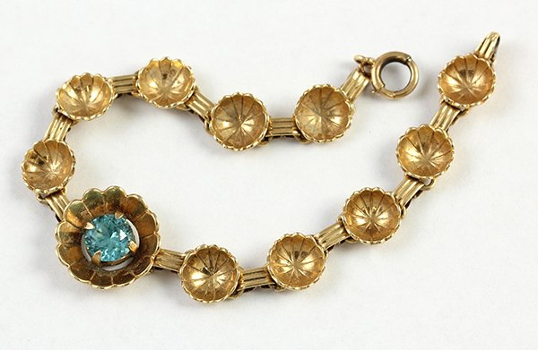 Blue zircon yellow gold bracelet: Blue zircon 14K yellow gold bracelet set with one round cut blue zircon weighing approximately 1.45 ct.; 10.4 grams; 6 1/2" long
