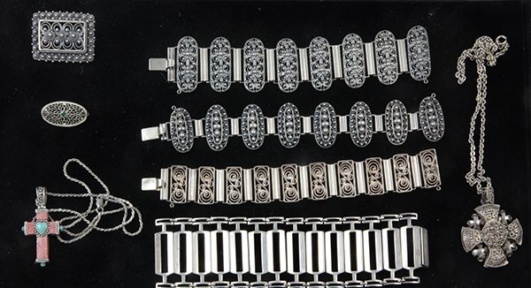 Norwegian .925 and .830 silver jewelry: (lot of 8) Norwegian fine .830 and .925 silver bracelets and pins some having filigree decoration; together with a Thailand sterling, mother of pearl, and carnelian cross pendant on a sterling rope ch