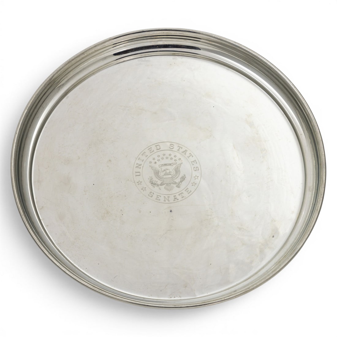A Salisbury Pewter tray with the Seal of the United States Senate: A Salisbury Pewter tray with the Seal of the United States Senate, 10.25"dia. Provenance: The Estate of Senator Dianne Feinstein (1933?2023) and Richard C. Blum (1935?2022)
