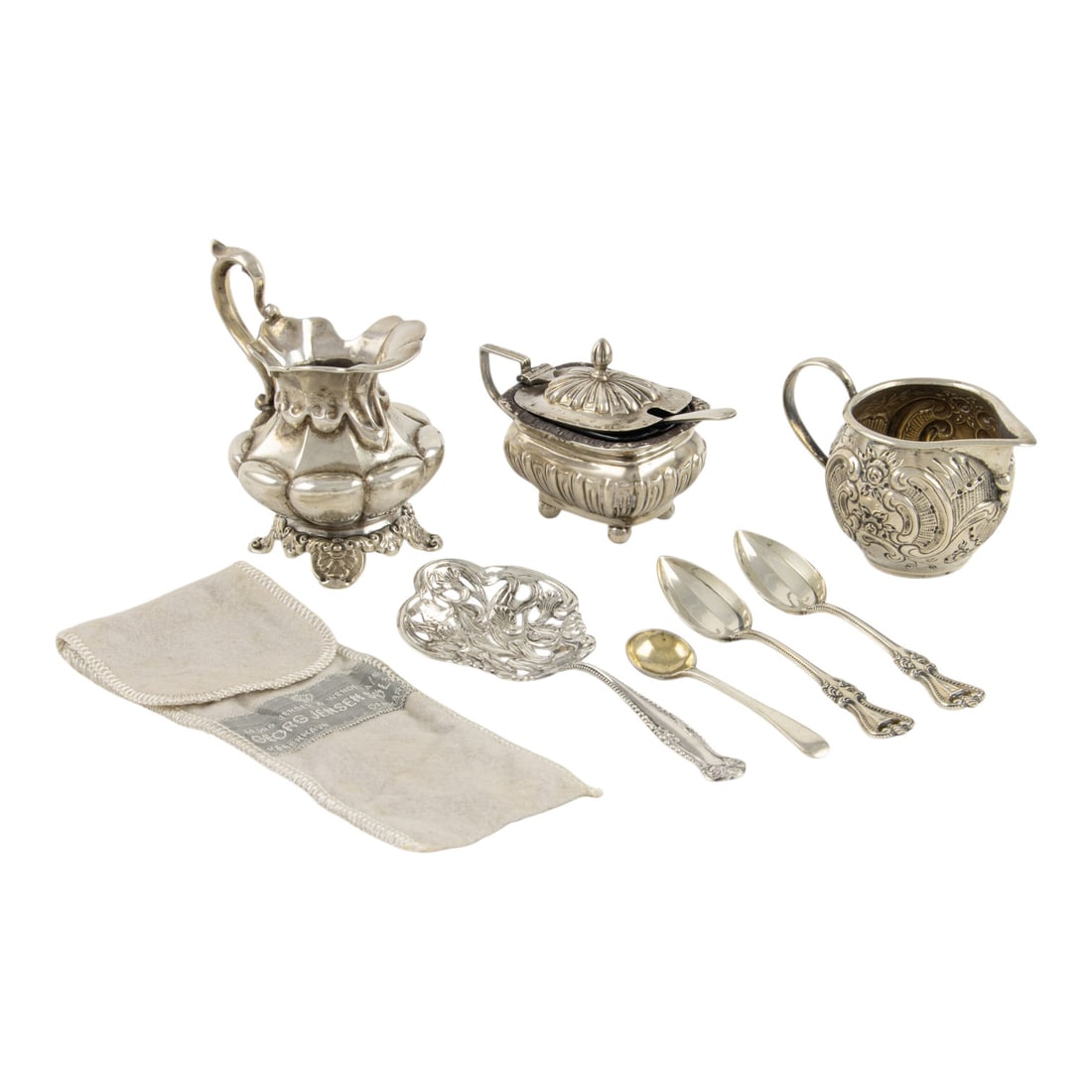A group of associated sterling including a Georg Jensen straining spoon: A group of associated sterling, comprising (1) Georg Jensen tea straining spoon, 4.75"l; (1) James Deakin & Sons, Chester salt with cover, cobalt liner and salt spoon, 2.25"h; (1) creamer, 3.25"h;