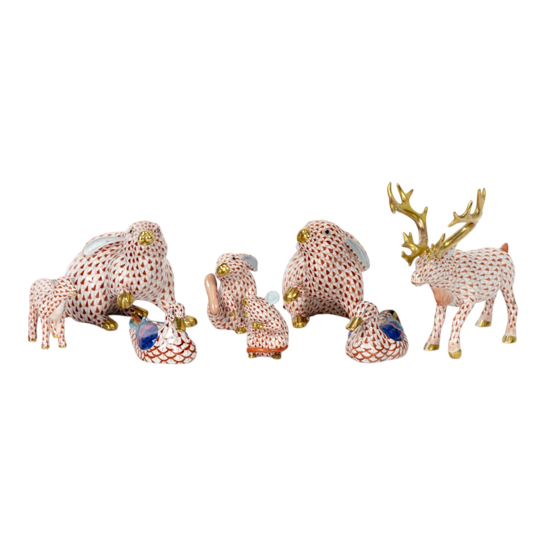 A group of eight Herend porcelain animals in a red fishnet pattern: A group of eight Herend porcelain animals in a red fishnet pattern, each with printed factory mark, comprising (1) stag 15659, 7"l; (2) rabbits 5335, 5.75"l; (2) ducks 15337, 3.5"l; (1) lamb 15479,