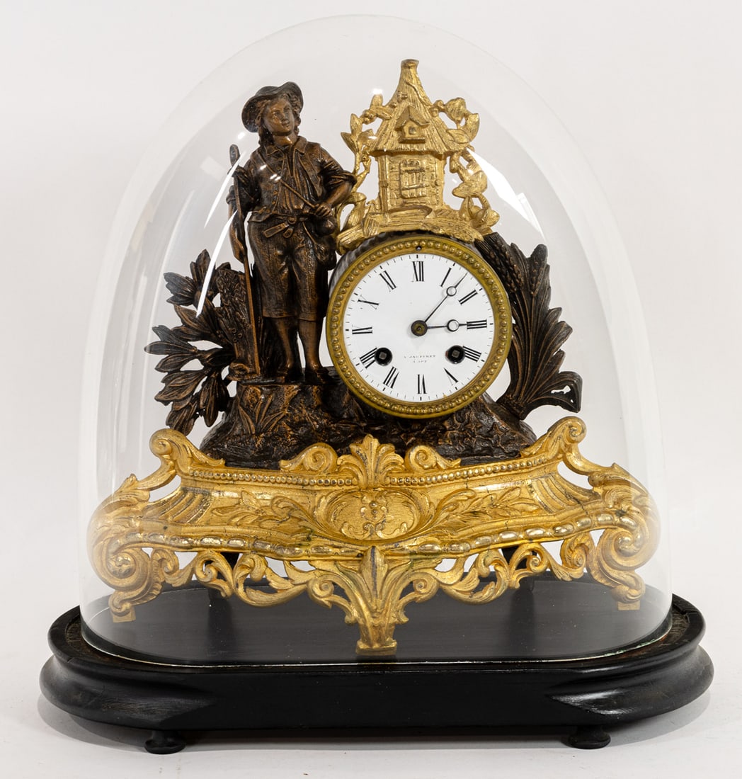 A French patinated and gilt metal figural clock: A French patinated and gilt metal figural clock, Jauffret, the time and strike movement sounding on a bell, housed within a drum beside a farmer, beneath glass dome and ebonized wood base, overall
