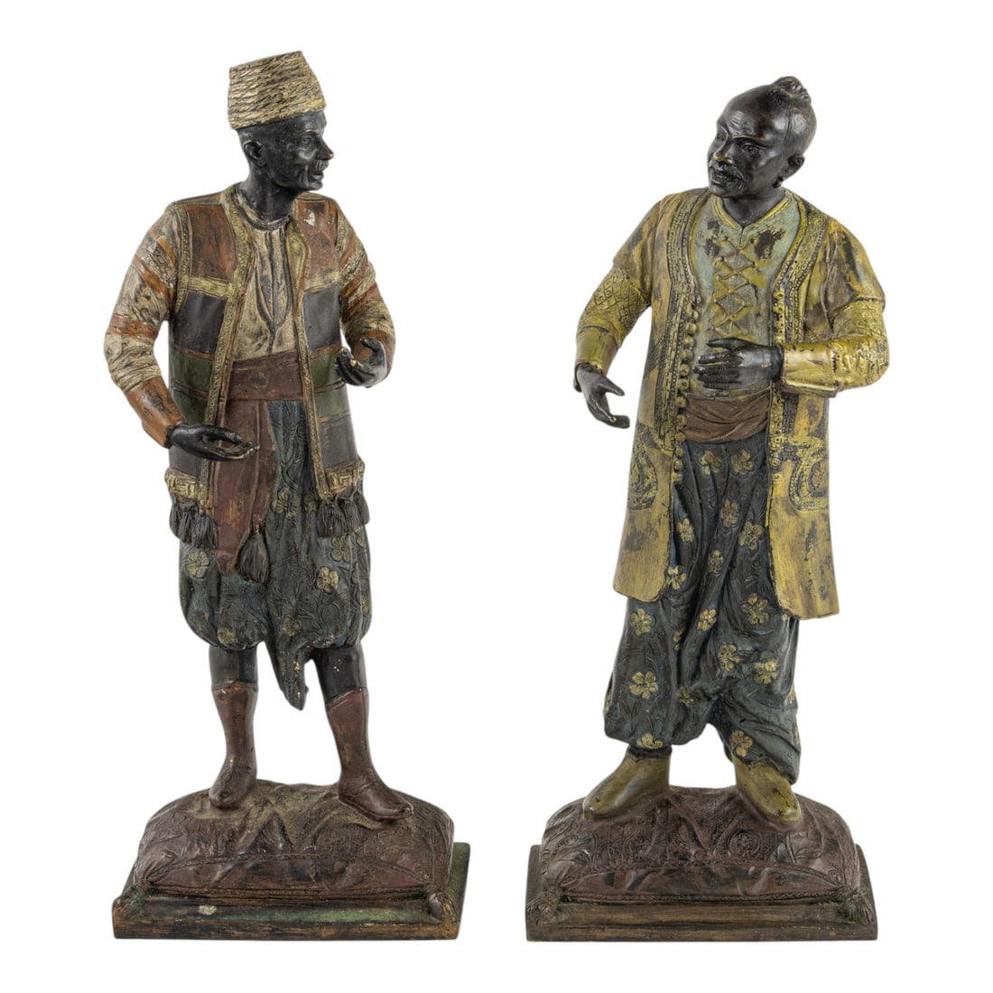 A pair of Austrian cold-painted bronze Orientalist figures: A pair of Austrian cold-painted bronze Orientalist figures, late 19th/early 20th century, each depicted in North African dress, one wearing a fez and the other with a top knot, unmarked, 12.5"h.