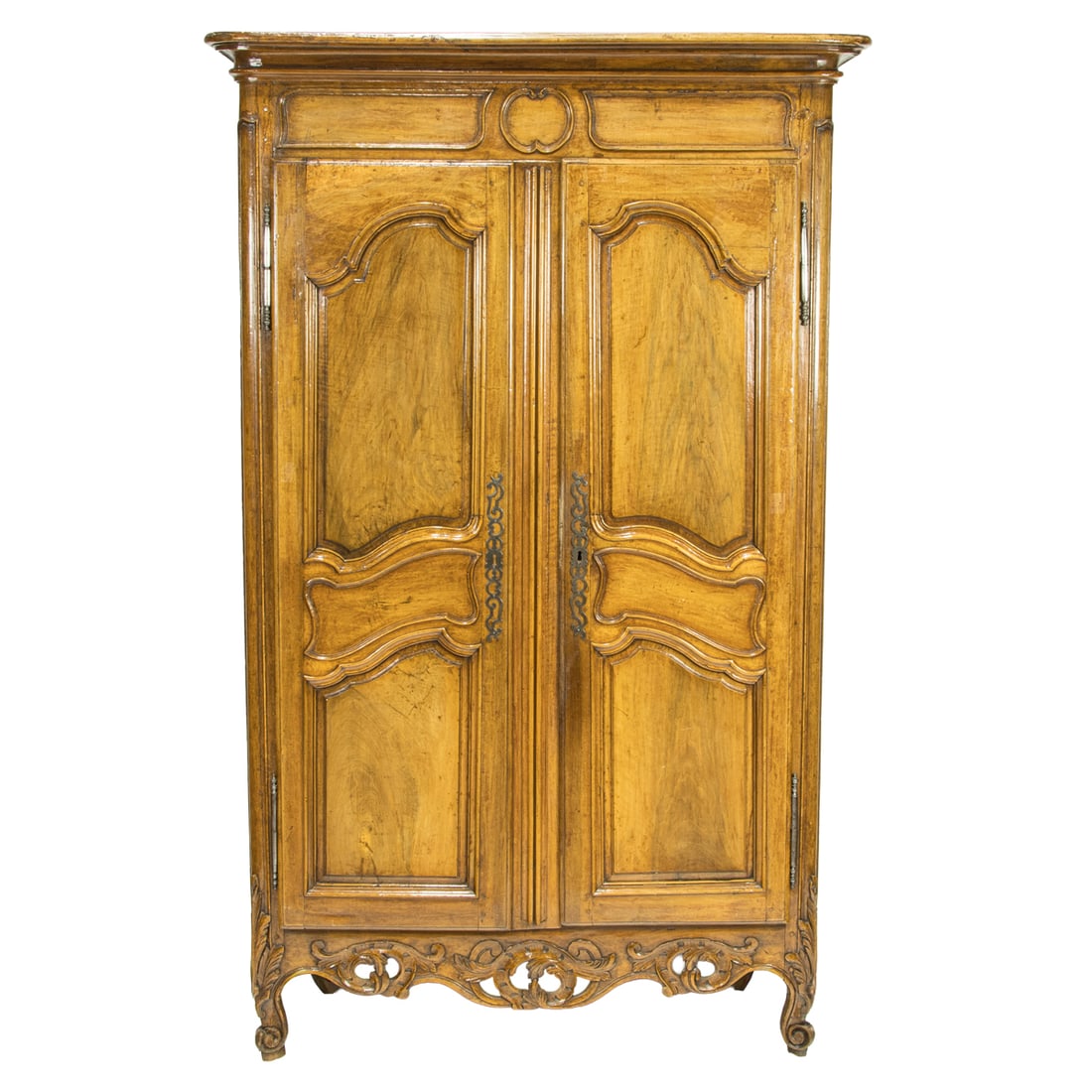 A French Louis XV Provincial armoire circa 1770: A French Louis XV Provincial armoire circa 1770, the two door case with raised panels and a reticulated rocaille reserve, and rising on carved outswept legs, 90"h x 50"w x 23"d