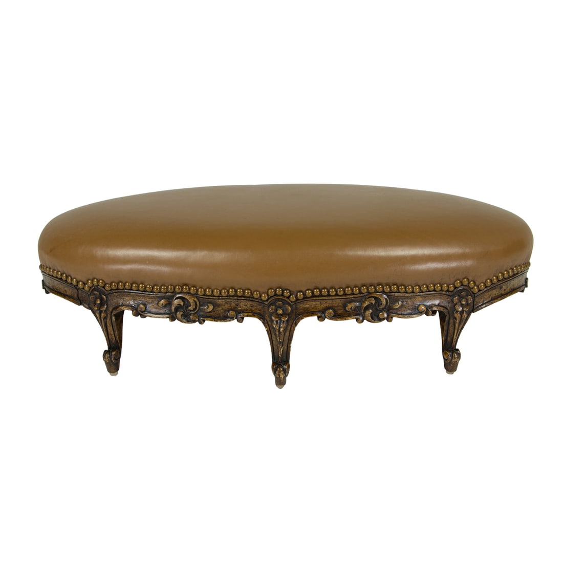A Louis XV style foot stool 19th century: A Louis XV style foot stool 19th century, the oval form with a leather cover having brass nail head trim, and rising on six rosette decorated cabriole legs, 9"h x 27.5"l x 12"d